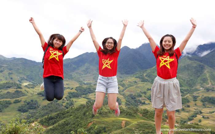 Exciting girls in Vietnam flag jumping on Sapa land