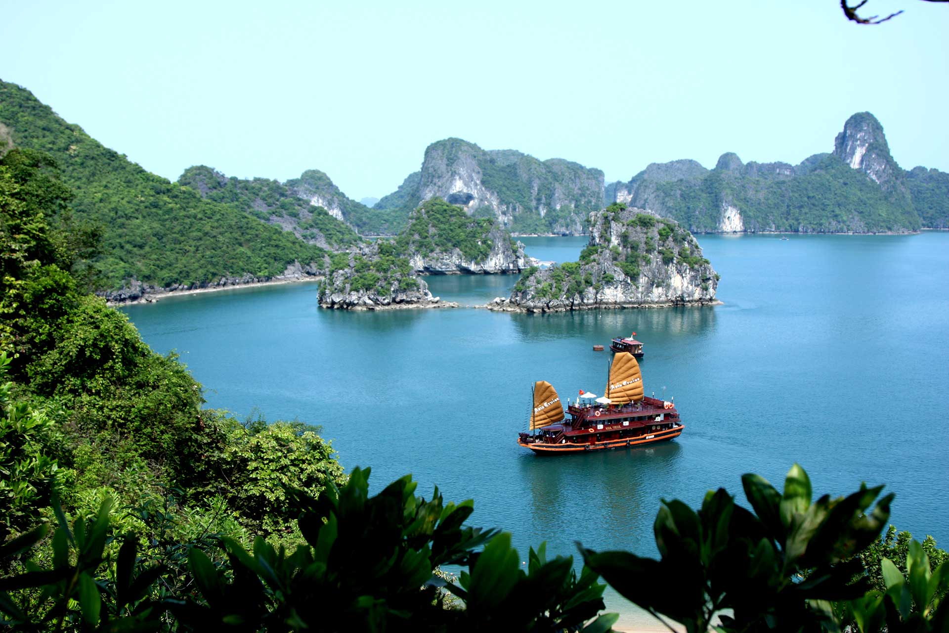 A cruise ship sailing on the emerald water of Halong Bay