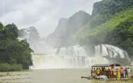 Tourists on the boat are going to enjoy and explore Ban Gioc waterfall