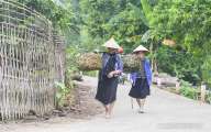 Ethnic woman are on village road