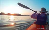 Kayak under sunset lights 