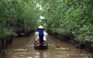 A traditional wooden sampan along canals in Mekong Delta