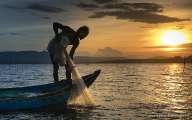 Fishing boat under sunset 