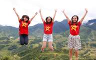 Exciting girls in Vietnam flag jumping on Sapa land