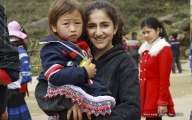Young tourist holding ethnic child