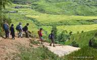 Trekking through yawning valleys decorated with terraced rice fields