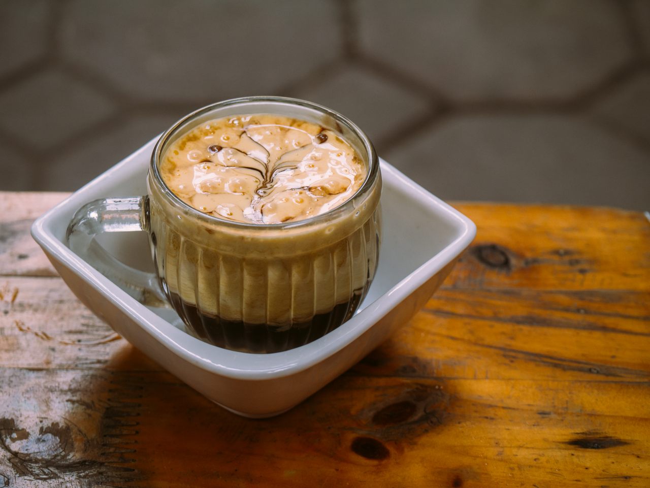 A Vietnamese Egg Coffee with a thick layer of frothy egg foam on top.